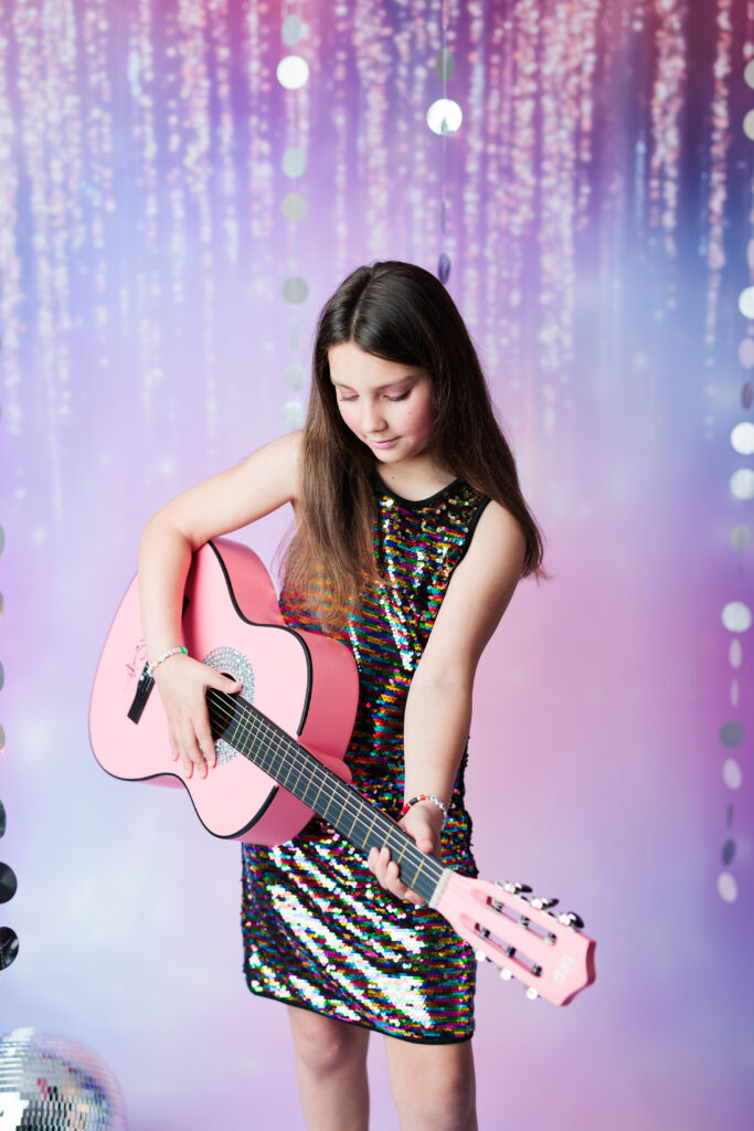 girl in glitter dress playing pink guitar Taylor Swift Photoshoot
