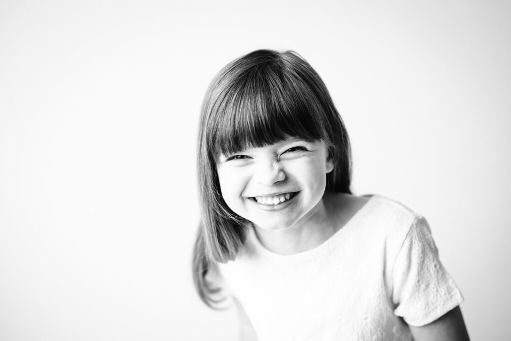 girl laughing in black and white photo