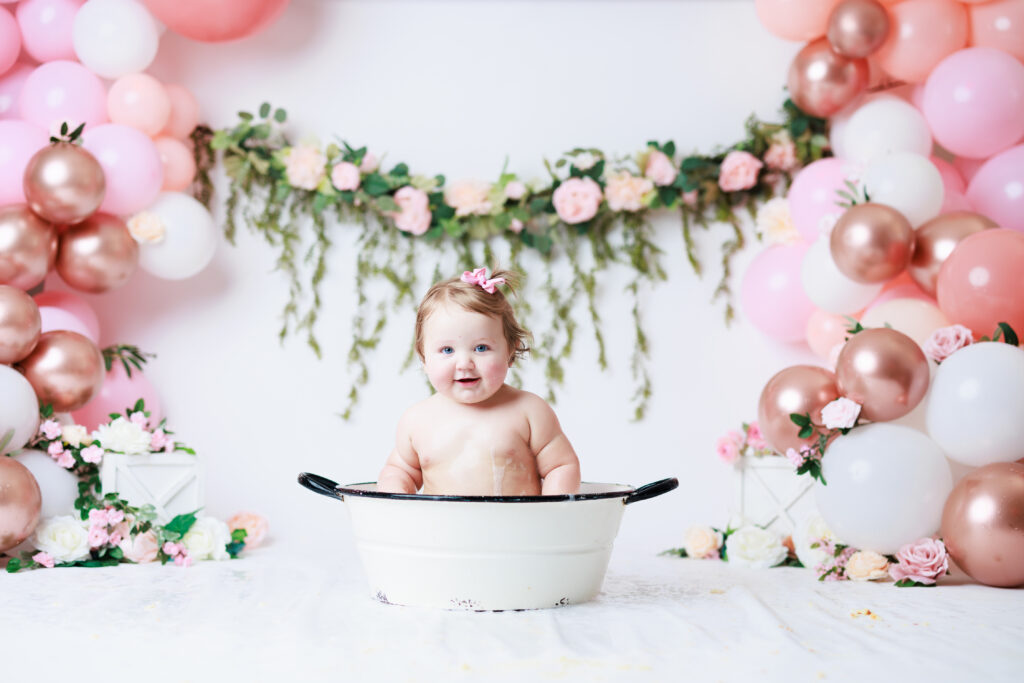 baby in bath surrounded by flowers