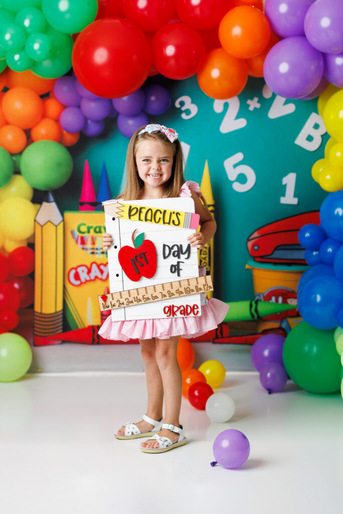 girl holding first day of school sign