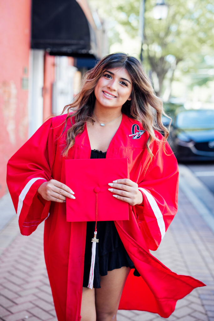 girl in high school senior red cap and gown 
