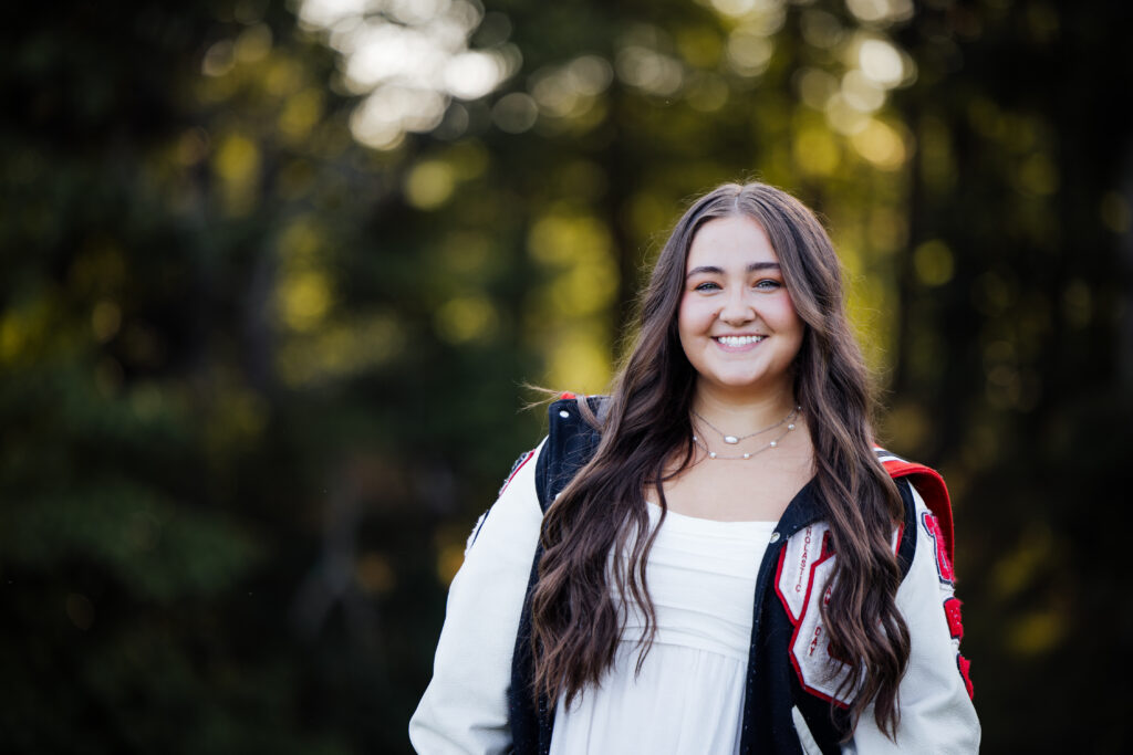 girl wearing Cherokee high school letter jacket graduation pictures