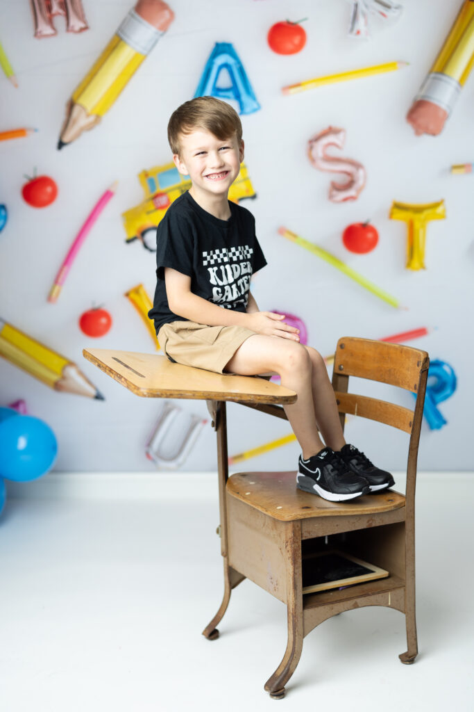 boy sitting on school desk 