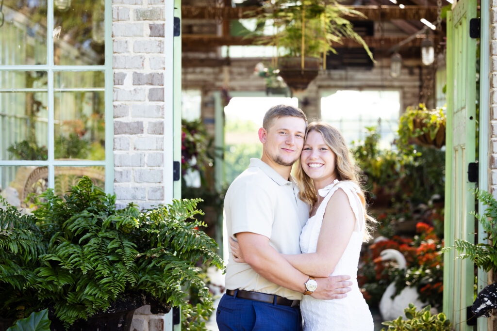 couple smiling at greenhouse