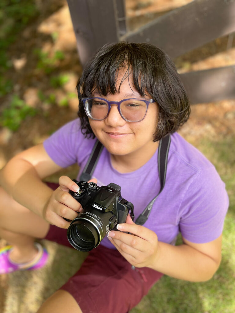 girl holding camera