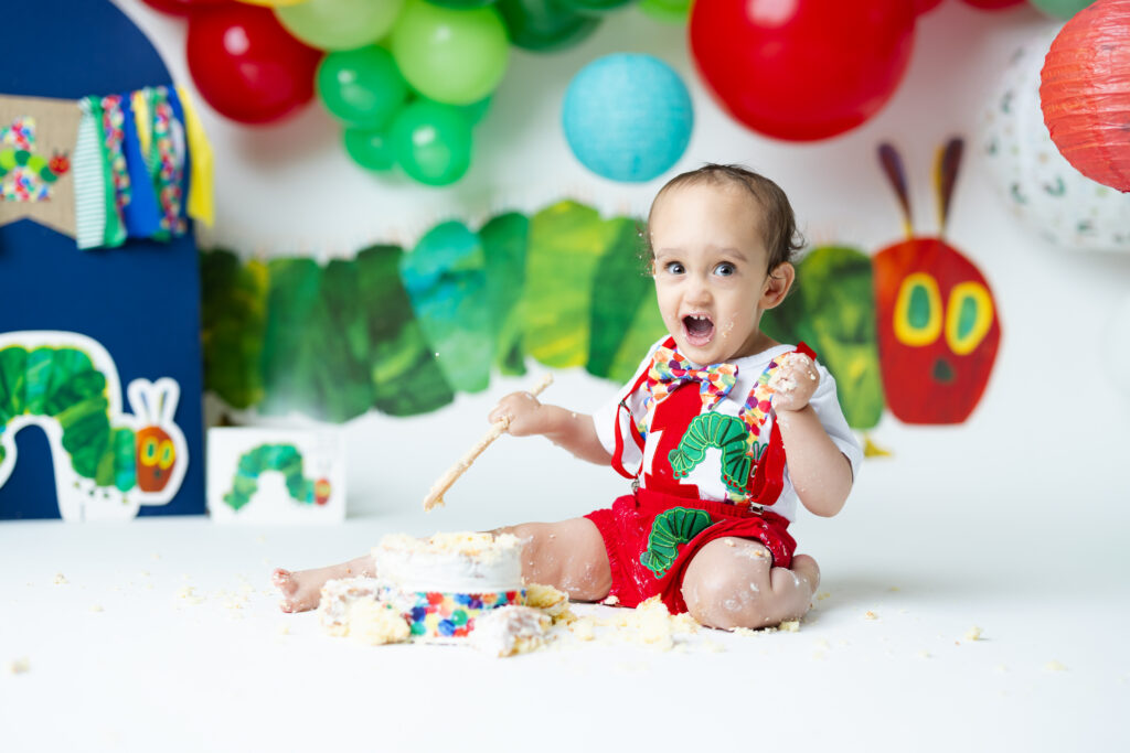 boy smiling during cake smash 