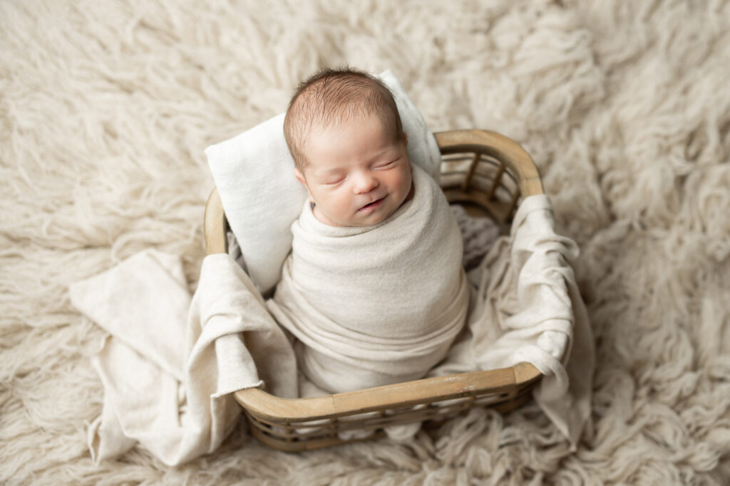 neutral newborn boy pose in basket photography session canton georgia