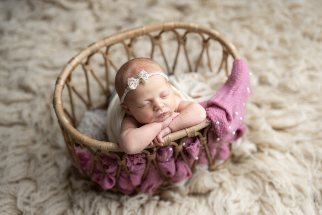 baby in basket pink pearls 