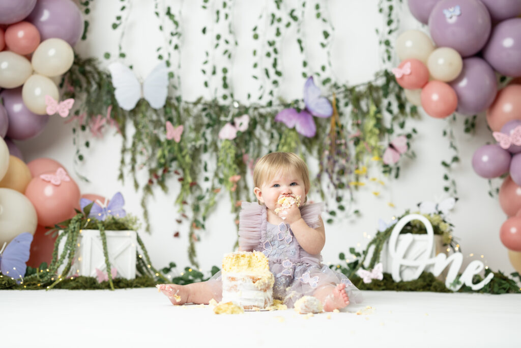 girl eating cake first birthday photographer 