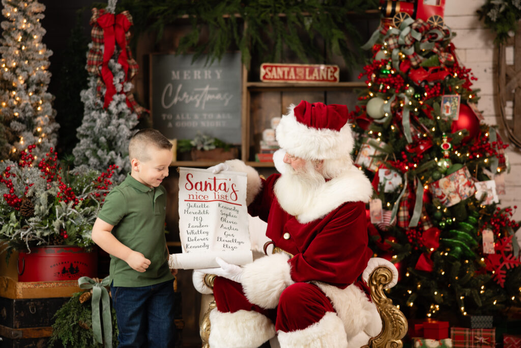 boy in green shirt checking the nice list