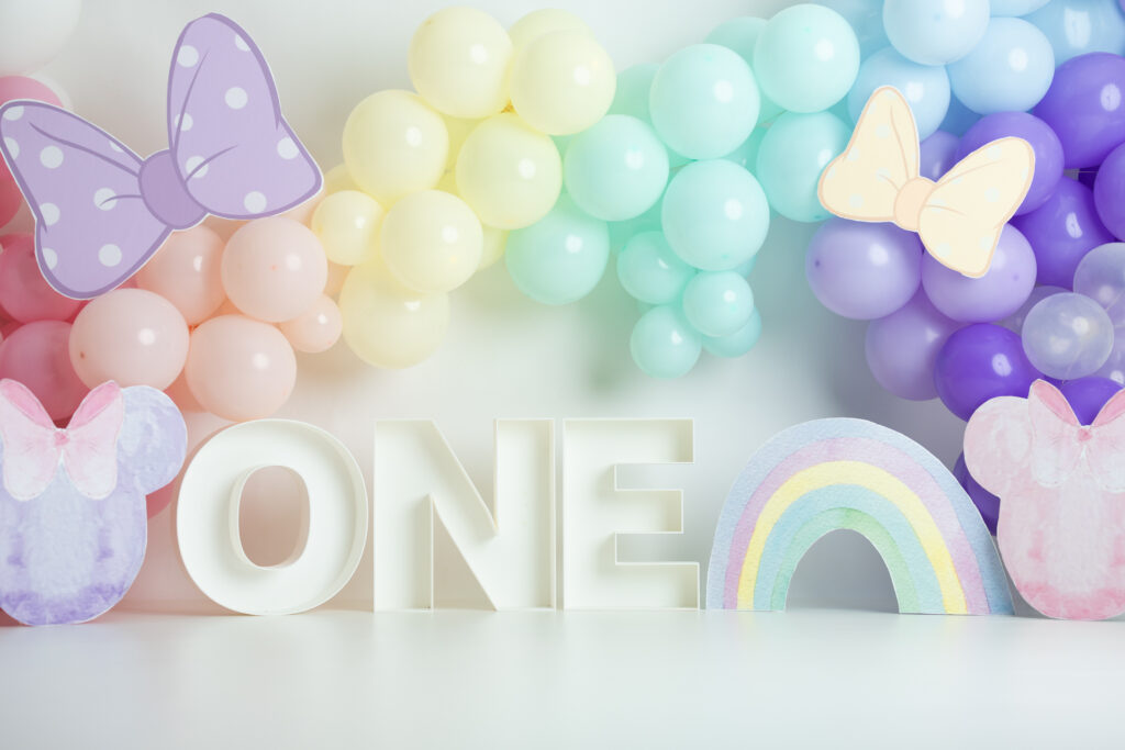 first birthday cake smash set up pastel minnie with rainbow with big one letters