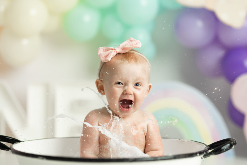 splashing baby in bathtub 