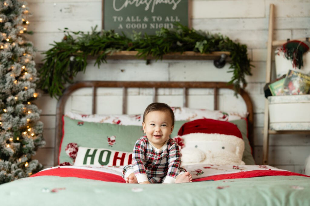 Fun and festive Christmas Pajamas session in Canton, GA studio with kids enjoying holiday decorations and personal books