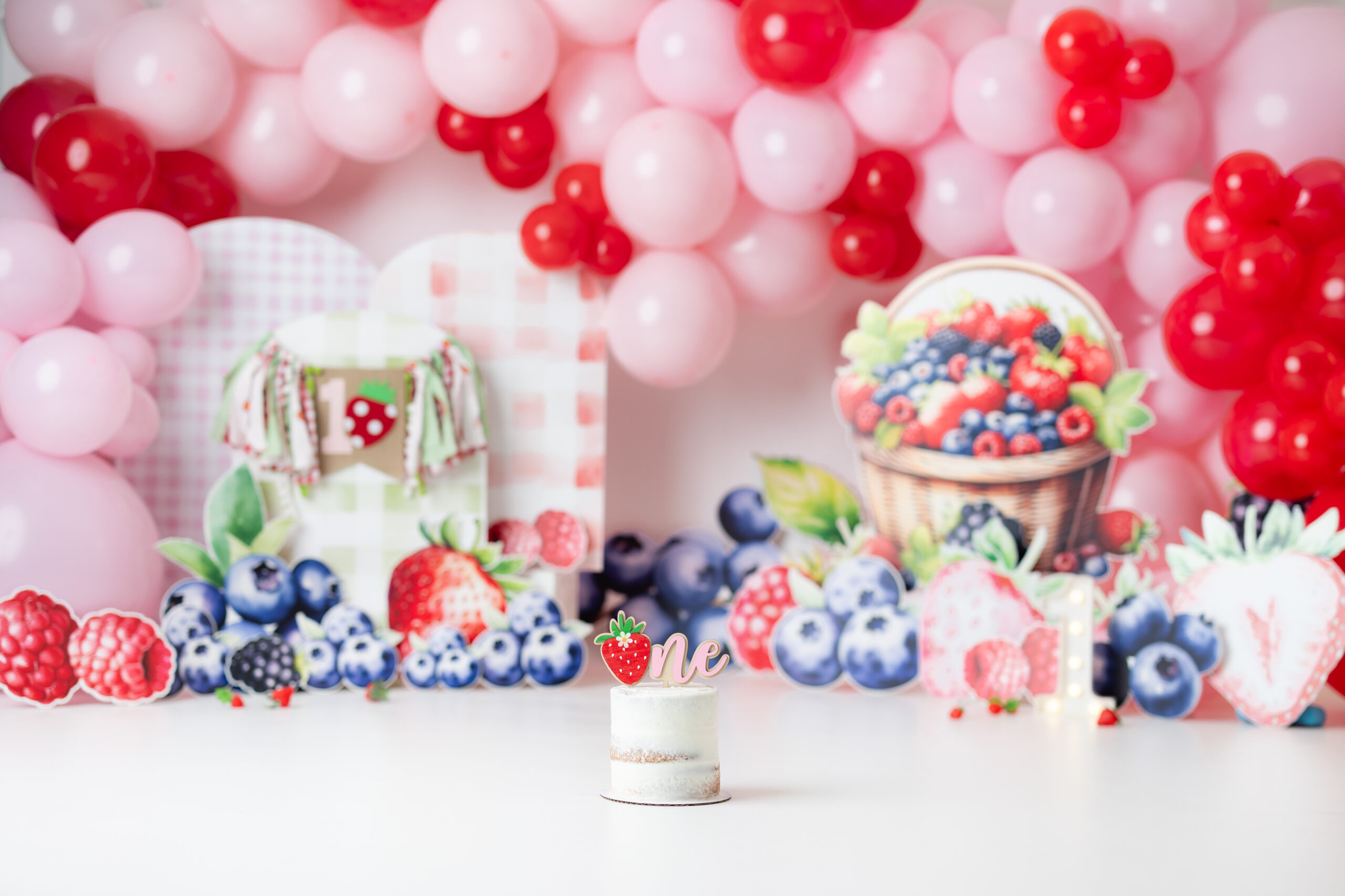 Berry First Birthday Cake Smash Canton GA with colorful balloons and custom berry decorations