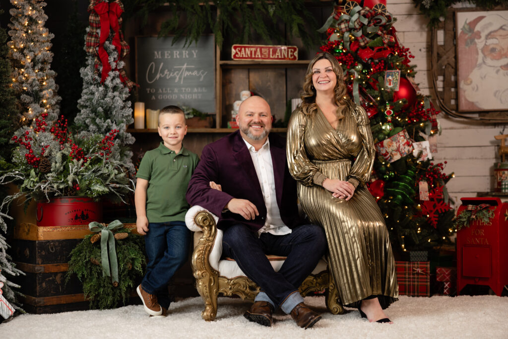 Family wearing coordinated Christmas outfits during Santa mini session in Canton GA