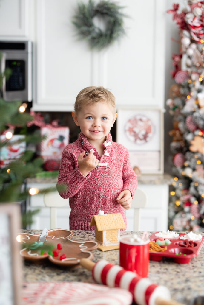 Child decorating gingerbread house during Holiday Baking Kitchen Sessions Canton GA