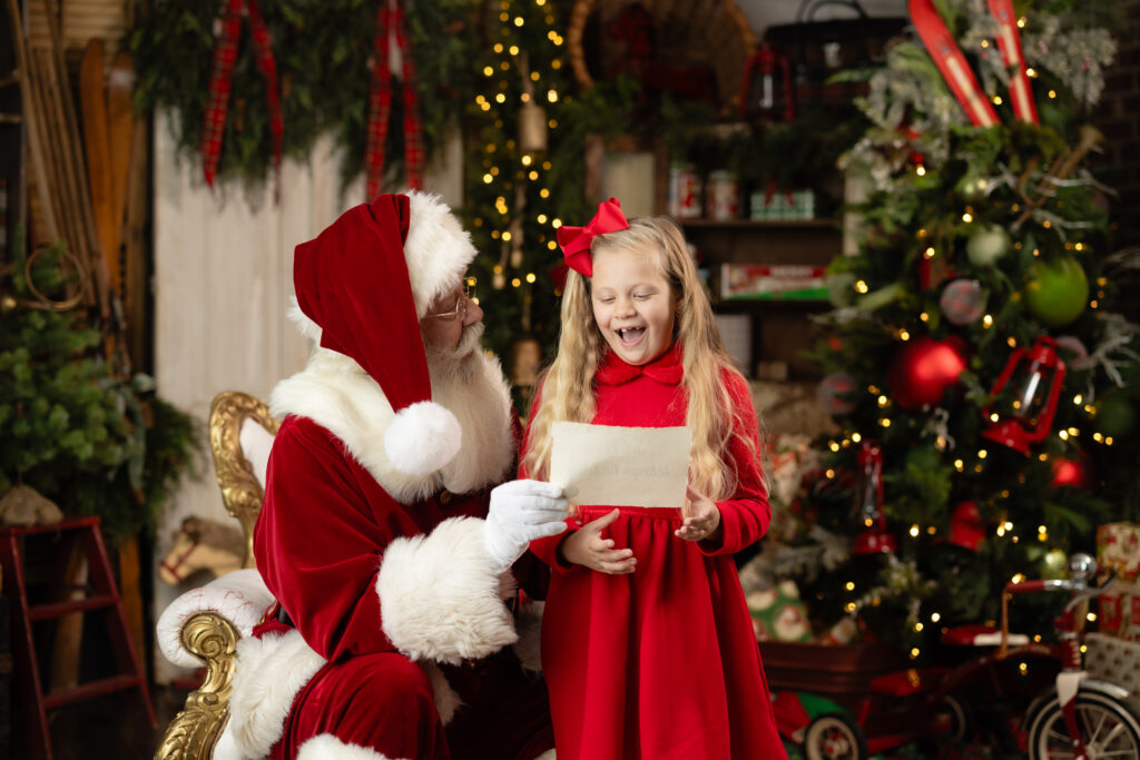 Santa reading with a young girl during A Date with Santa 2026 Canton GA photography session.