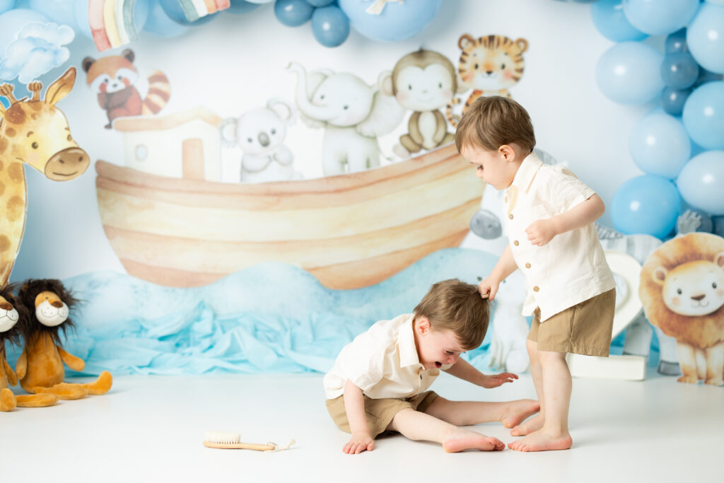 Twin brothers playing during Noah’s Ark birthday photoshoot Canton GA