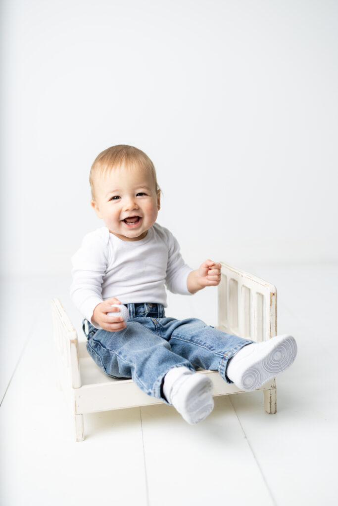 Smiling baby boy during golf themed first birthday cake smash