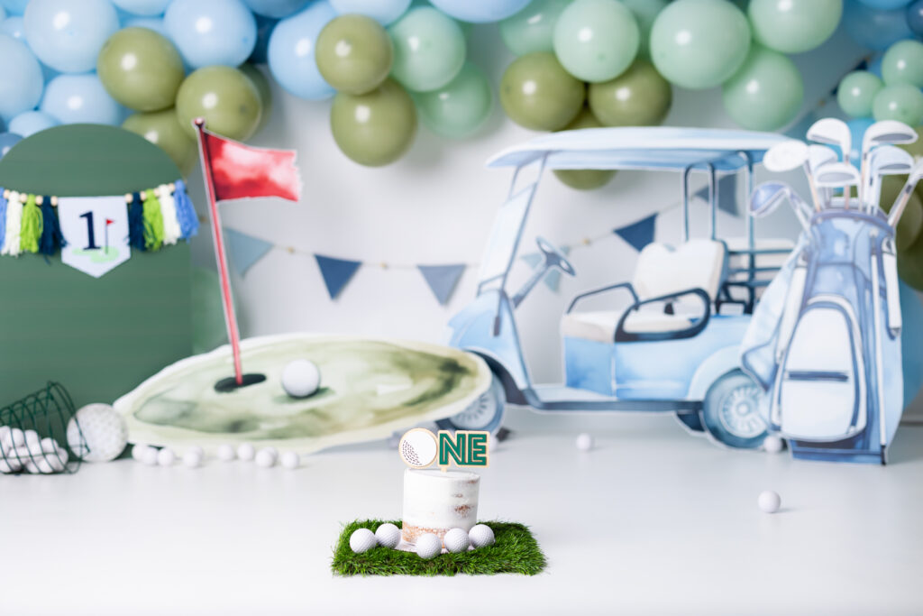 Golf cake smash Canton GA first birthday photos with golf themed backdrop