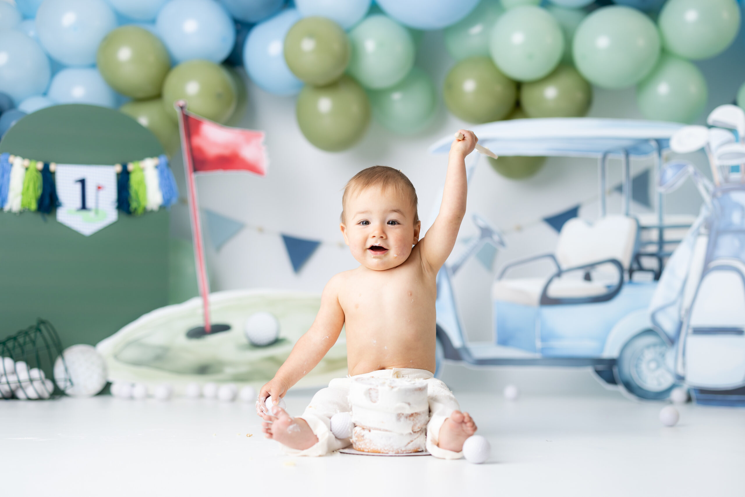 golf themed cake smash first birthday pictures little boy smiling
