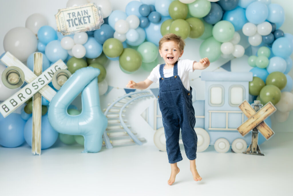 Child jumping with excitement during birthday photography session