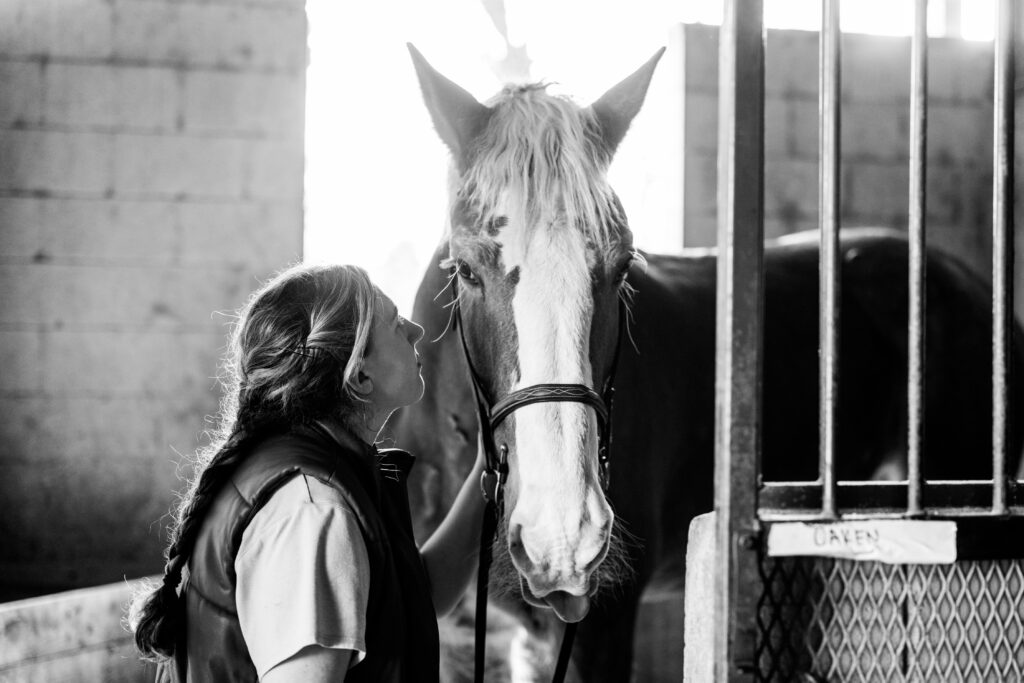 Senior portrait with horse inside barn North Georgia