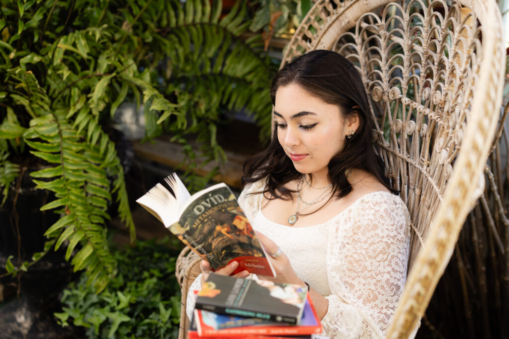 Senior portrait reading books during senior photo session Canton GA
