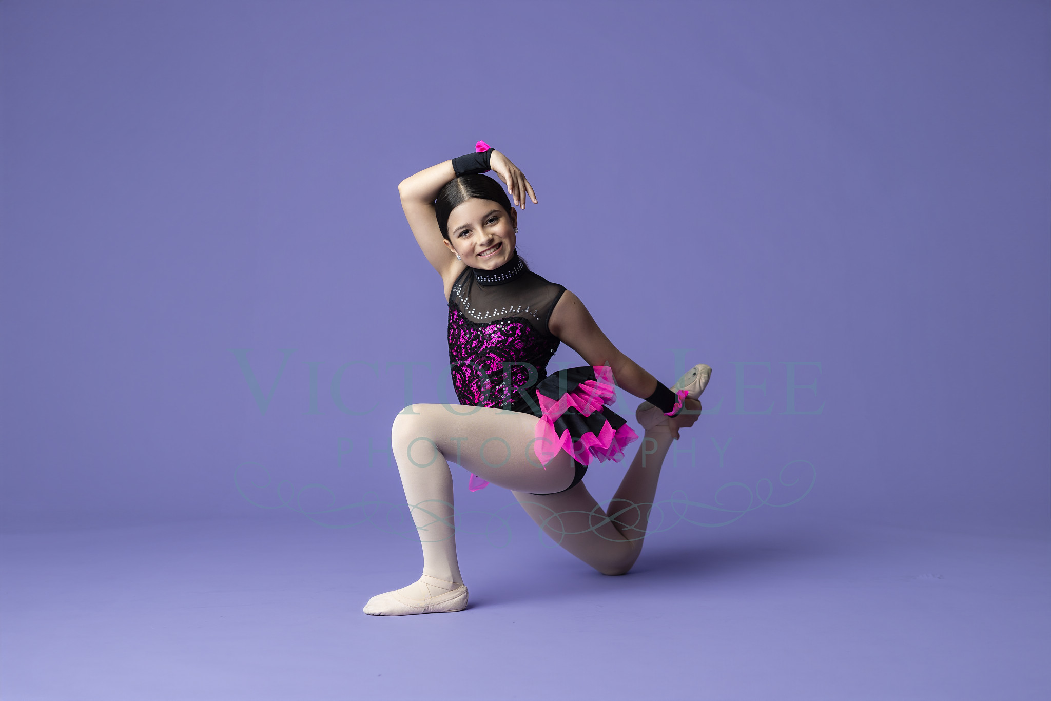 Dance portrait with black and pink costume smiling